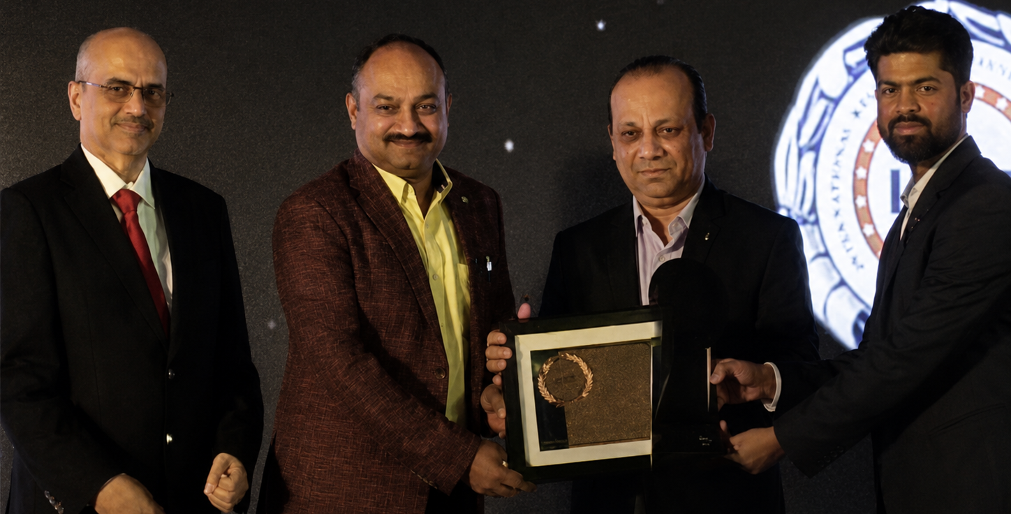 Geofast representatives receiving an award plaque on stage
